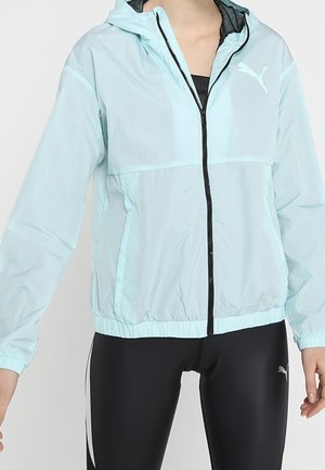 Veste coupe-vent légère de couleur vert menthe, avec une doublure intérieure noire, zip avant intégral et poignets élastiques. Dotée d'un logo Puma sur la poitrine.