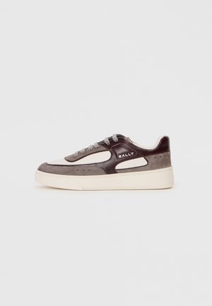 White and gray sneaker with a brown leather accent, textured suede, round toe, lace-up front, and a thick cream-colored sole.