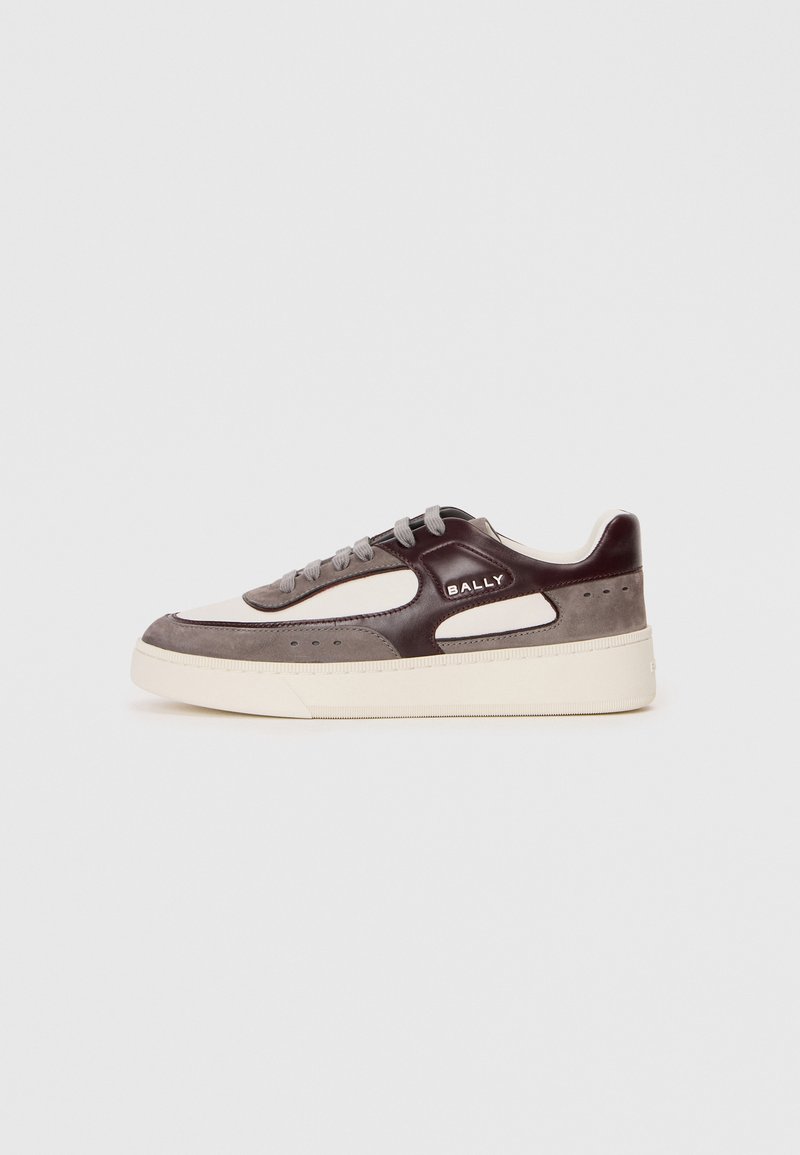 White and gray sneaker with a brown leather accent, textured suede, round toe, lace-up front, and a thick cream-colored sole.