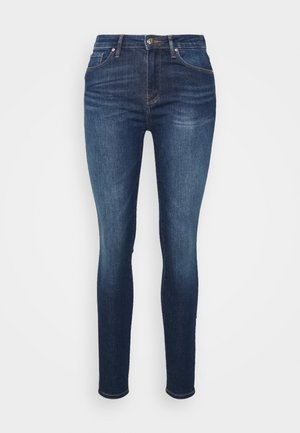 Skinny jeans in dark blue denim, featuring a classic five-pocket design, subtle fading, and a button-fastening front.