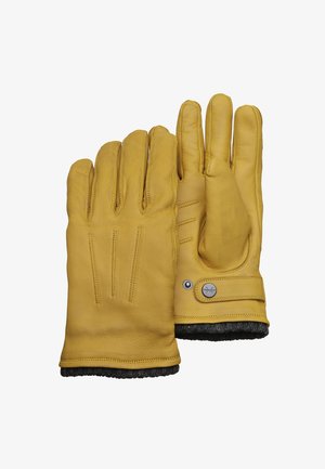 Gele leren handschoenen met een zachte voering, drie duidelijke stiksels op de rug en een drukknoopdetail op de pols.