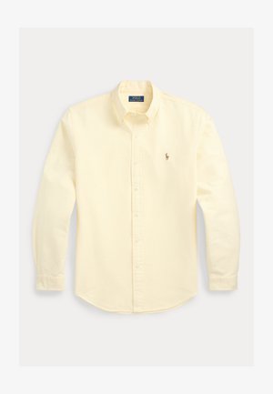 Gulstripet langermet skjorte med knapper og klassisk krage, med en liten brodert logo på venstre bryst. Bomullsstoff.