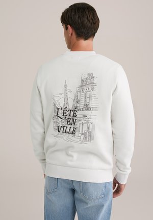 Witte sweatshirt met een geprinte omtrekillustratie van Parijse monumenten en de tekst "L'été en ville" op de achterkant. Klassieke ronde halslijn.