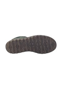 Semelle de chaussure verte avec caoutchouc texturé pour l'adhérence, comportant des rainures et des motifs circulaires. Comprend des détails de logo et un bord renforcé.