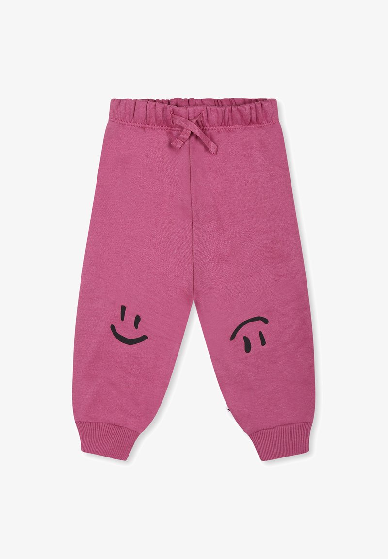 Pantaloni da jogger rosa con cintura elastica e cordoncino. Presentano design di faccine sorridenti nere su ciascuna gamba. Tessuto morbido con polsini a coste.