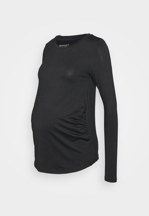Camisola de maternidade de manga longa preta com decote redondo, apresentando franzidos nas laterais para maior elasticidade e um design ajustado. Textura suave.