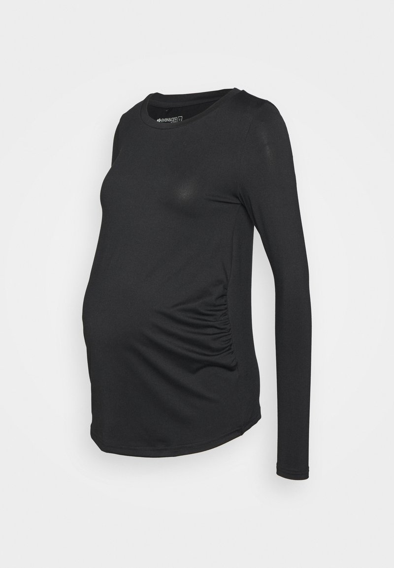 Camisola de maternidade de manga longa preta com decote redondo, apresentando franzidos nas laterais para maior elasticidade e um design ajustado. Textura suave.