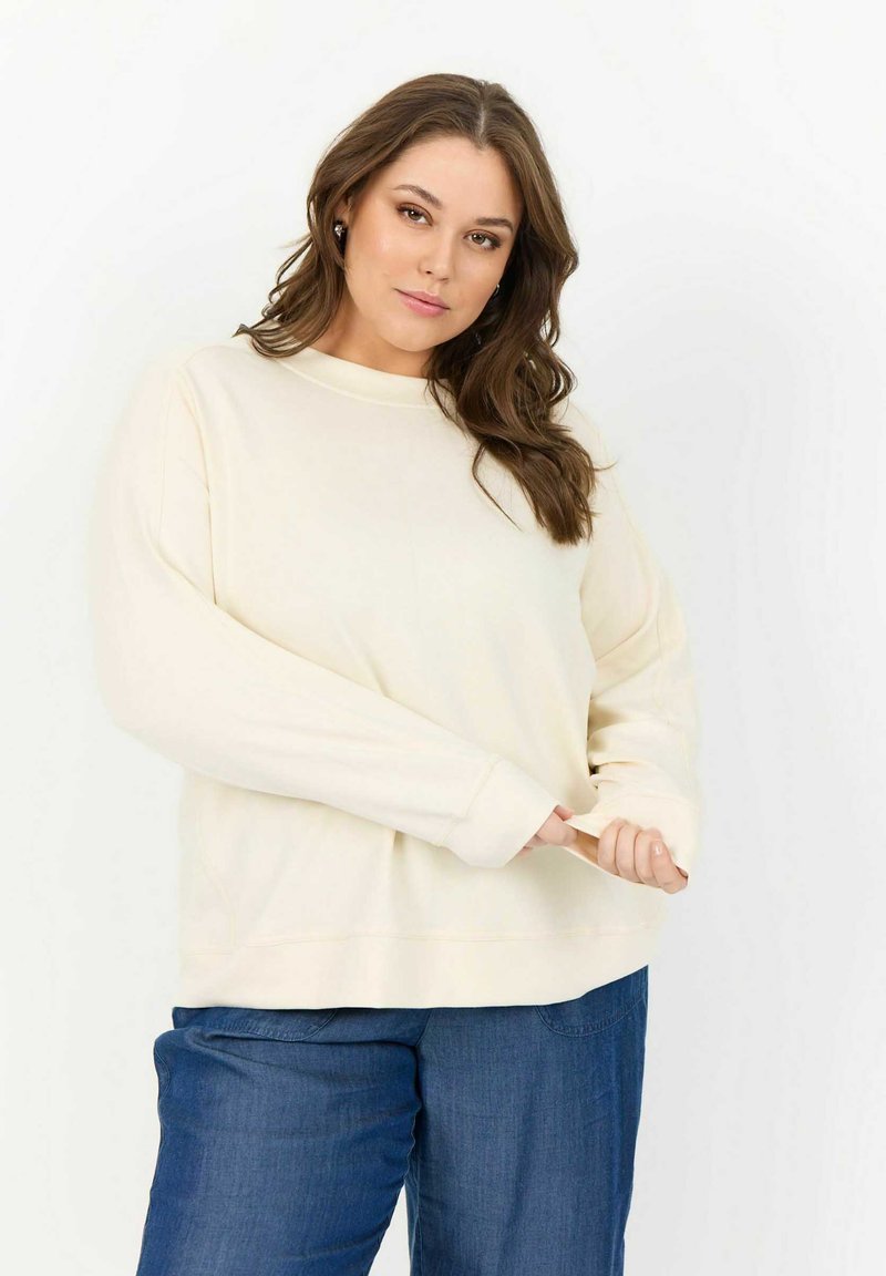 Cremfarbener Sweatshirt mit Rundhalsausschnitt, langen Ärmeln und lockerer Passform. Hergestellt aus weichem Stoff mit sichtbaren Nähakzenten.