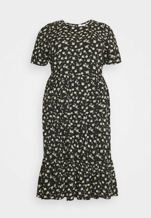 Schwarzes Blumenkleid mit kleinen weißen Blumen, kurzen Ärmeln, rundem Ausschnitt und ausgestelltem Saum mit dezenten Rüschen am unteren Rand.