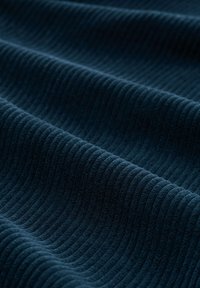 Textuurstof in donker marineblauw met verhoogde horizontale strepen, die een zachte, ribbelige oppervlakte en een gladde afwerking toont.