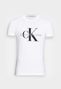 Biała koszulka z krótkim rękawem z czarnym i szarym logo "CK Calvin Klein Jeans" umieszczonym na środku klatki piersiowej, okrągły dekolt.