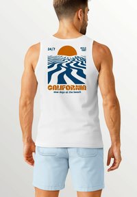 White sleeveless tank top featuring a retro graphic of a sun, ocean waves, and "CALIFORNIA" in orange text at the back.