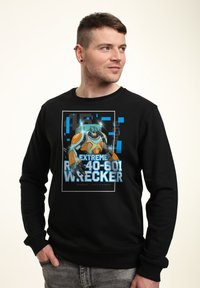 Schwarzer Kapuzenpullover mit einem grafischen Druck eines blauen und orangefarbenen Roboters mit dem Text "EXTREME R40-601 WRECKER" und einem rechteckigen Rahmen.