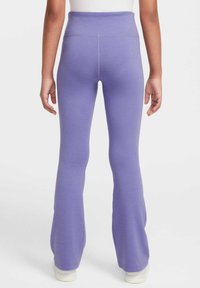 Leggings morados acampanados con una cintura alta, hechos de un tejido suave y elástico. Terminados con costuras limpias y una textura suave.