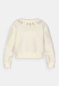 Sudadera de color crema con cuello redondo, mangas largas y intrincados patrones de diamantes bordados en la parte superior.