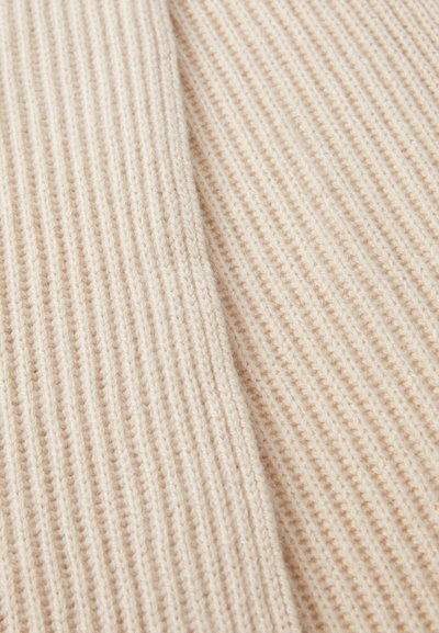 Beige knit fabric with ribbed texture, featuring fine, alternating light and dark beige stripes. Soft and slightly fluffy appearance.