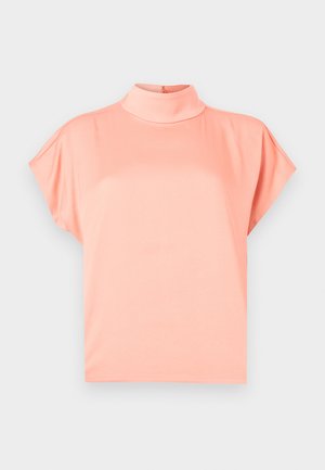 Light coral short-sleeve blouse with mock neck and loose fit, displayed on a plain light gray background.