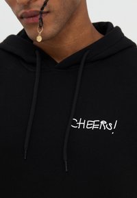 YOURTURN UNISEX - Sweat à capuche - black