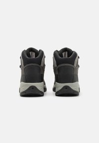 Black and gray hiking boots with a high-top design, mesh panels, reinforced heel, and textured rubber outsole for traction.