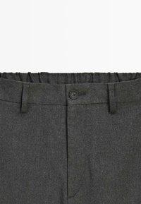 Donkergrijze wollen broek met elastische achterkant, enkele zwarte knop, knoopsgat en riemlussen, weergegeven op een witte achtergrond.