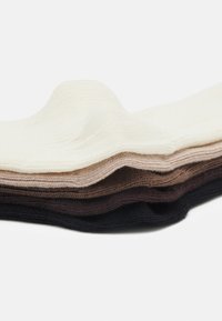 Cotton socks layered in a gradient from cream to various shades of brown, featuring a textured knit and ribbed edges.