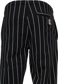 Karl Kani SIGNATURE PINSTRIPE PANTS UNISEX - Treniņtērpa apakšdaļas - black