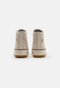 Beige ankle boots with textured fabric and smooth leather accents. Features a rubber sole and a padded collar for comfort.