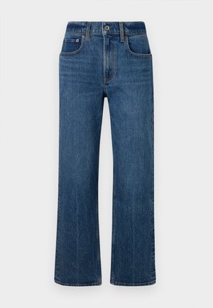 Jeans a gamba larga in denim blu esposti su uno sfondo bianco semplice, con tasche frontali, chiusura con bottoni e una finitura leggermente sbiadita.