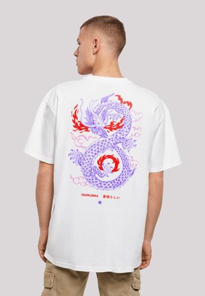 White oversized t-shirt featuring a colorful dragon graphic in purple and red on the back, with text below in a contrasting color.