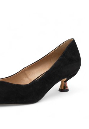 Schwarzer Wildlederpumps mit einem niedrigen, goldakzentuierten Kegelfuß. Das Innere verfügt über ein glattes, beige Futter. Runde Spitze und minimalistisches Design.