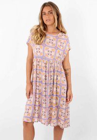Robe à motif floral dans des couleurs pastel, avec des manches courtes, une coupe ample, taille froncée et une longueur midi. Tissu en mélange de coton.
