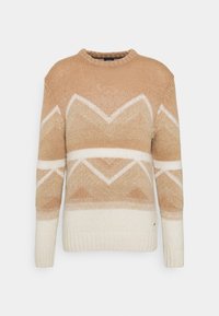 Pull en maille avec un col rond, présentant un motif géométrique beige et crème. Le matériau semble doux avec des poignets et un ourlet côtelés texturés.