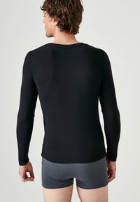 Damart COL ROND FINE SENSITIVE MANCHES LONGUES - Unterhemd/-shirt - noir