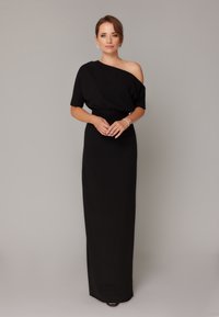 Czarna, bez ramiączek, długa sukienka z dopasowaną talią i swobodną sylwetką. Miękka tkanina, minimalistyczny design, odpowiednia na okazje formalne.
