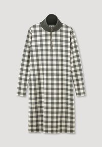 Robe à carreaux avec un col zippé quart, manches longues, en tissu doux dans une palette de couleurs noir, blanc et gris.