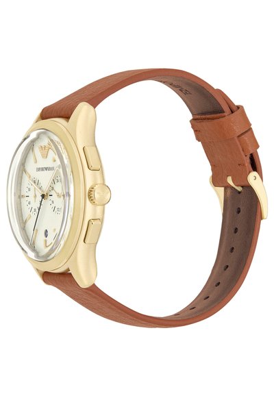 Goldfarbene Armbanduhr mit einem klaren Glaseinsatz, cremefarbenem Zifferblatt, braunem Lederarmband und zwei Druckknöpfen an der Seite zur Funktionalität.