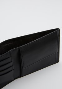 Black leather wallet with multiple card slots, a flat pocket, smooth texture, and subtle stitching detail along the edges.