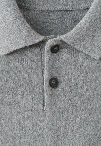 Gray knitted polo shirt featuring a soft texture, two black buttons, and a classic collar. The material appears lightweight and breathable.