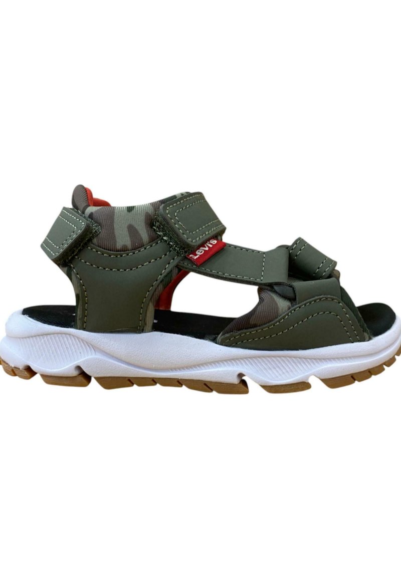 Sandalias de color verde oliva con correas de Velcro, suela acolchada, entresuela blanca texturizada y suela de goma. Presentan un forro interior de camuflaje.