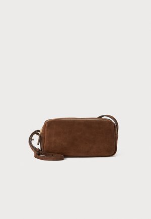 Brown suede bag with a flat rectangular shape, a zip closure, and a detachable strap. Features smooth texture and minimalistic design.