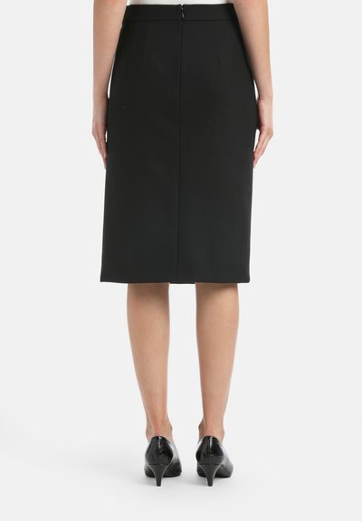 Black knee-length pencil skirt with a zip closure at the back, featuring subtle pleats and smooth texture, paired with black heels.
