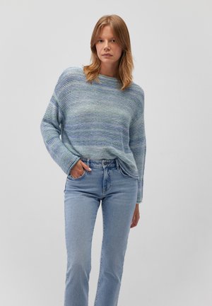 Light blue striped sweater with a relaxed fit, wide sleeves, and a round neckline, paired with light blue jeans.