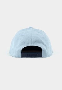 Light blue cap made of textured fabric, featuring a dark navy plastic adjustable strap and ventilation holes on the back.