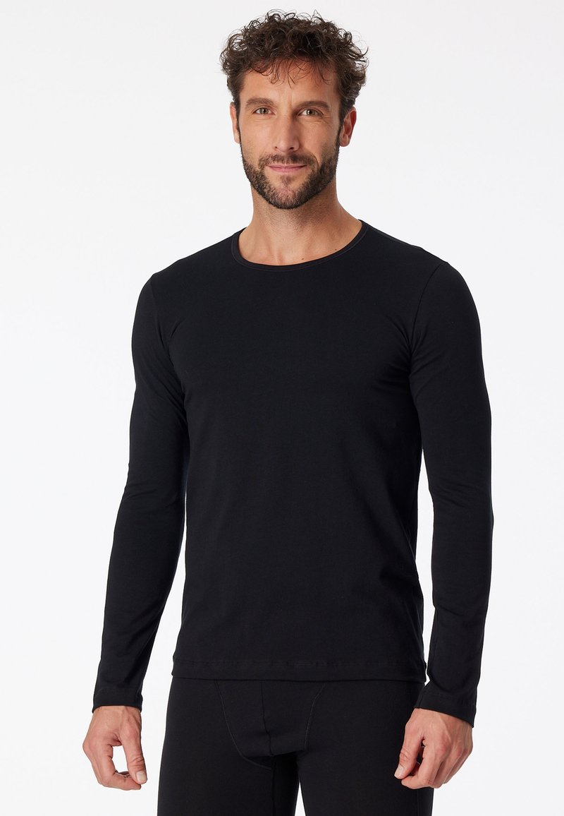 Zwarte longsleeve t-shirt van rekbare stof, met een ronde halslijn en een aansluitend ontwerp, met naadloze manchetten en onderrand.
