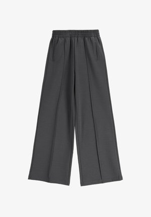 Ciemnoszare spodnie o szerokich nogawkach z elastycznym paskiem i pionowymi bocznymi kieszeniami, wykonane z miękkiej, teksturowanej tkaniny.