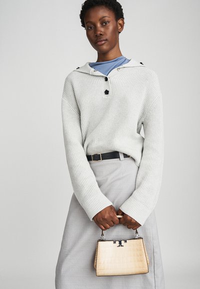 Light gray ribbed sweater with a hood, button details, and a black belt. The model holds a small, textured beige handbag with silver hardware.