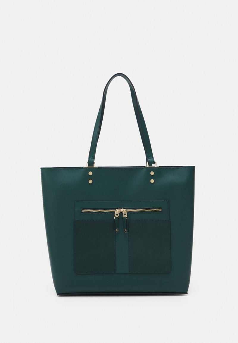 Sac cabas en cuir vert foncé avec deux longues anses, poche avant zippée avec doubles tirettes dorées et deux compartiments cousus en dessous.