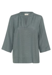 Blusa in teal con texture, scollo a V, maniche 3/4 e taglio dritto. Realizzata in tessuto leggero, adatta per un look casual.