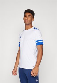 White athletic T-shirt with blue striped accents on the sleeves and shoulders, made from lightweight material, featuring a round neckline.