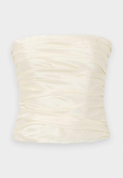 Ilma rihmadega top iivrisatäänist, millel on pleeditud tekstuur ja sile viimistlus, laia ja struktureeritud siluetiga.